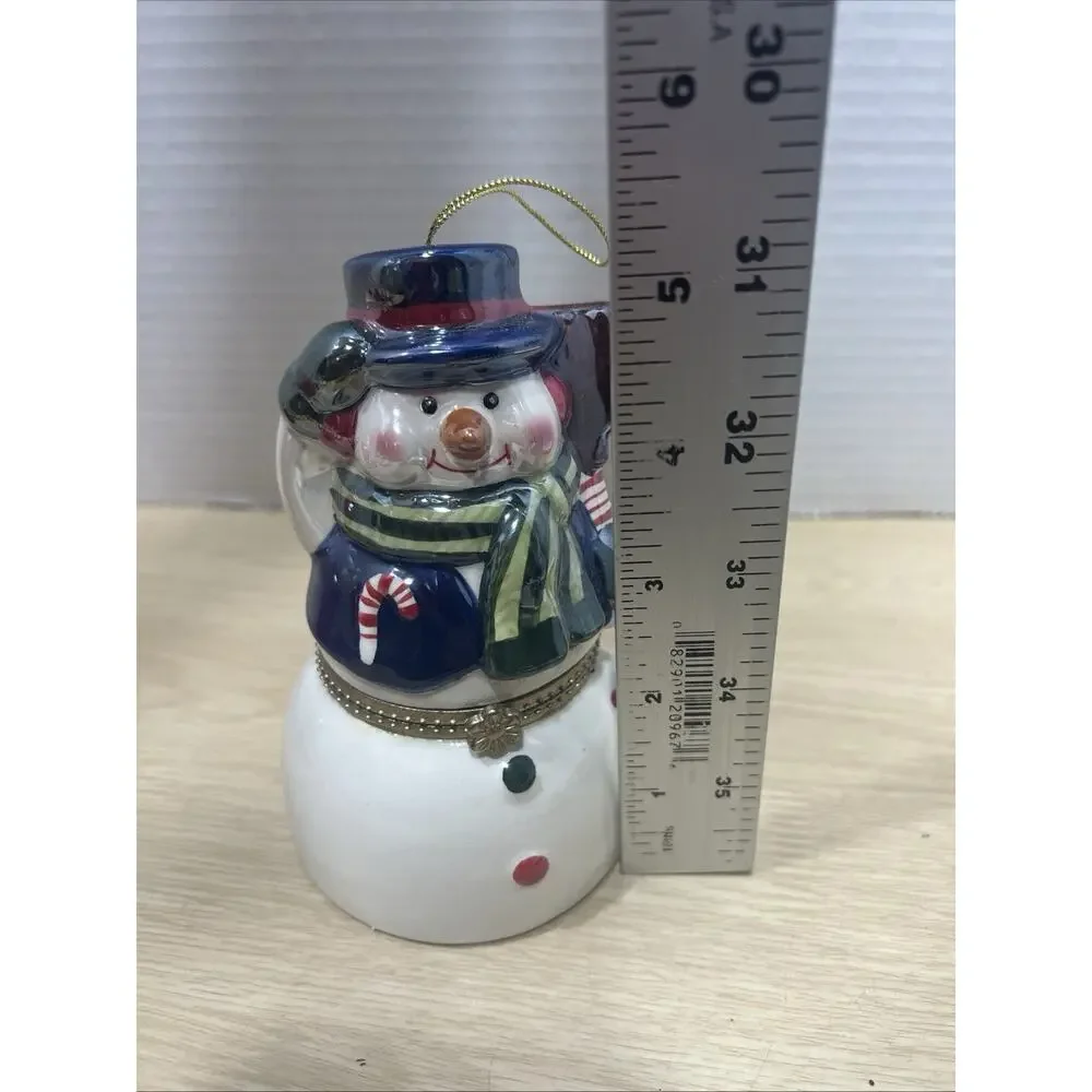 Mr. Christmas Porcelain Snowman is a Hinged Music Box Ornament